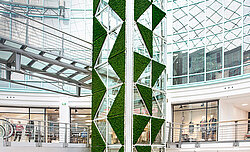 Maintenance-free moss triangles in moss green installed around the lift in the Rostocker Hof shopping centre